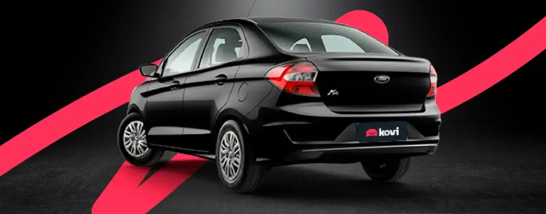 Traseira do Ford Ka sedan preto em fundo preto, com linha ondulada rosa